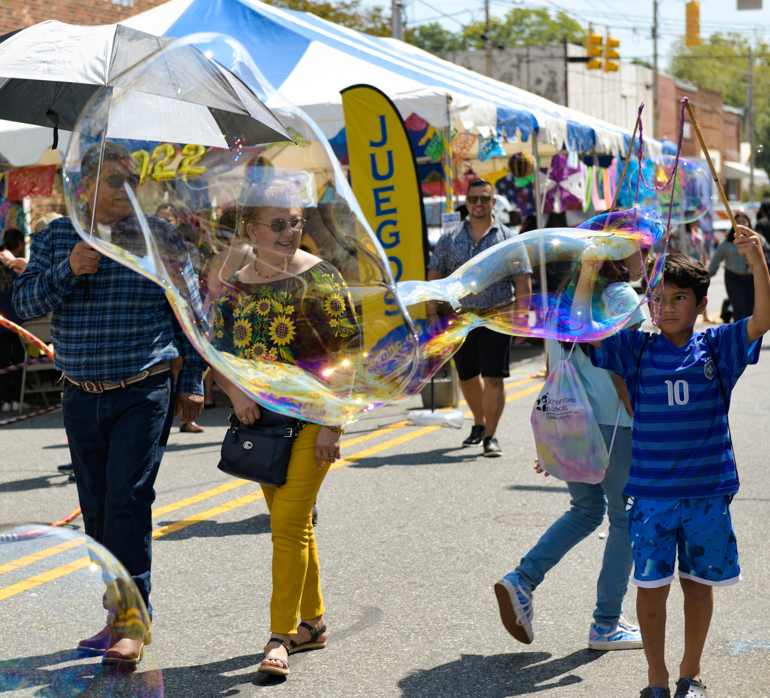 Kids play at the bubble station at Saturday's Hispanic Heritage Festival.